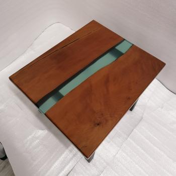 Preview: Couchtisch aus Massivholz und Kunstharz auf einem Metallgestell.